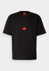 Black cotton t-shirt with short sleeves, featuring a red rubber logo in the center and a red inner neck label. Simple and classic design.