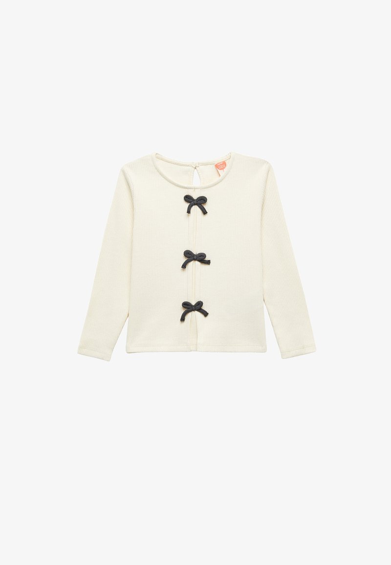 Creme kleurig overhemd met lange mouwen van ribbelstof, met drie zwarte strikaccenten en een sleutelgatopening aan de achterkant.