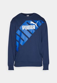 Sudadera azul marino hecha de una mezcla de algodón, con un logo de PUMA en azul bold y un diseño gráfico en la parte delantera. Cuello redondo y mangas largas.