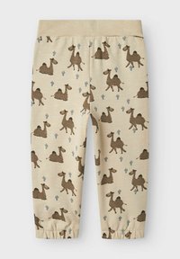 Ljust beige leggings med ett lekfullt mönster av kameler i brunt, med blå kaktusdetaljer och elastiska mudd vid anklarna.