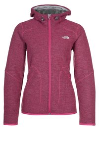 Rosa fleecejacka med huva, åtsittande design, dragkedjestängning, kontrasterande dragkedjor och sidofickor. Mjuk textur med subtilt melerat mönster.