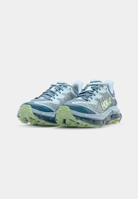 Light blue running shoes with a textured mesh upper, dark blue accents, lime green midsole, and a patterned outsole designed for traction.