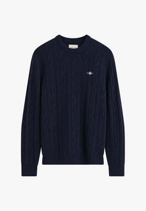 Suéter de punto de cable azul marino con un escote redondo, puños y dobladillo acanalados. Presenta un pequeño logo en el pecho. Elaborado en un material de mezcla de lana texturizada.