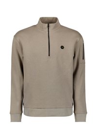 Beige sweatvest met ritssluiting en hoge kraag, zwarte accenten op de mouwen, geribbelde manchetten en een klein zeshoekig logo op de borst. Zachte textuur.