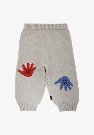 Pantalon en tricot gris avec des poignets côtelés, orné de motifs de mains rouges et bleues avec des visages souriants de chaque côté. Tissu doux et texturé.