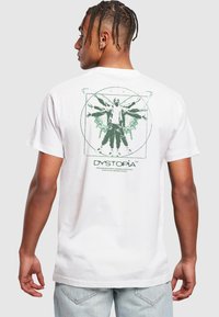 White cotton t-shirt featuring a green graphic design on the back, depicting a figure with wings and geometric elements. Short sleeves, standard fit.