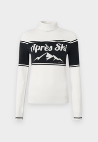 Hvit genser med høy hals og svart øvre del, "Après Ski"-tekst og fjellgrafikk over brystet, ribbestrikkede mansjetter og kant.
