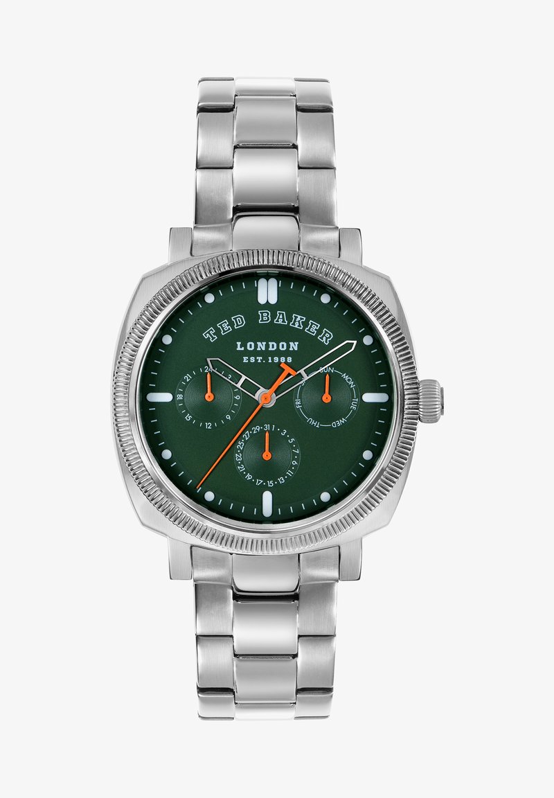 Sudraba metāla pulkstenis ar zaļu ciparnīcu, baltām un oranžām akcentiem un trim subciparnīcām. Iespējo teksturēts borti un ķēdes tipa aproce.