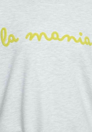 Helekollane kange kangas, mille keskel on kollase kursiivkirjaga kiri "la mamia".