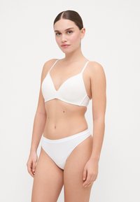 White bra and matching bikini bottom, both with a smooth texture. Bra features a V-neck design and thin adjustable straps.