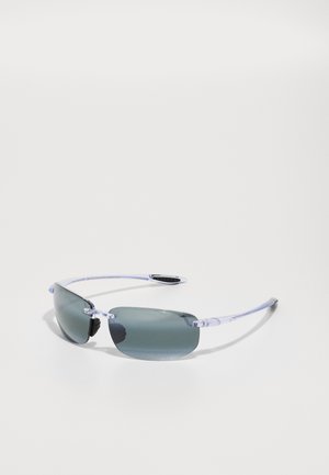 Sunglasses with a transparent frame and gradient gray lenses. Thin, straight arms with black rubber accents for grip. Angular lens shape.