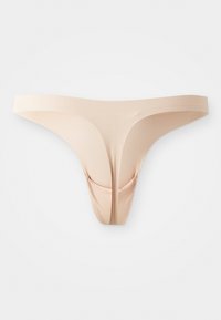 Nude spalvos stringai, pagaminti iš minkštos, elastingos medžiagos. Pasižymi minimalistiniu dizainu su plonomis juostelėmis ir lygiu paviršiumi.