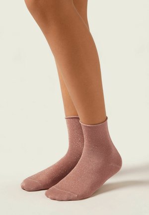 Rose gold ankle socks with a soft, textured finish, featuring subtle sparkles throughout the fabric for added detail.