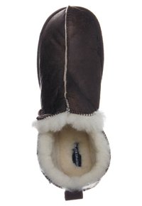 Brun lädersandal med vit fluffy foder och synlig inre etikett, sedd uppifrån, designad för värme och komfort.