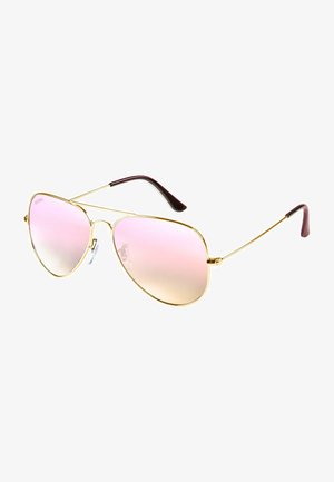 Arany aviátor napszemüveg, rózsaszín gradiens lencsékkel és sötét bordó díszítéssel ellátott szárvégekkel. Slim fém keret, állítható orrtámaszokkal.