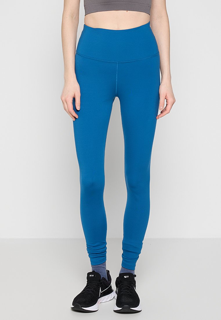 Hochtaillierte blaue Leggings aus dehnbarem, glattem Stoff. Verfügt über ein eng anliegendes Design mit einem nahtlosen Bund und schmal zulaufenden Beinen.