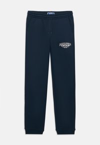 Marineblaue Jogginghosen mit elastischem Bund, seitlichen Taschen und einem in Weiß auf dem oberen linken Oberschenkel aufgedruckten Logo. Weicher Baumwollmischstoff.