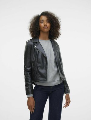 Black leather biker jacket with silver hardware, zippered pockets, and a fitted design, worn over a gray sweatshirt and dark jeans.