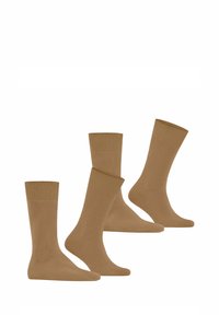 Brązowe bawełniane skarpetki o gładkiej fakturze, z prążkowanym ściągaczem i różnymi wysokościami. Trzy pary ułożone w grupie.