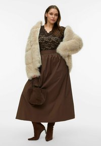 Pruun pitsist top, beež kunstkarusnahast mantel, pruun seelik, pruunid kontsadega saapad ja väike pruun kott. Omadusteks on pehmed tekstuurid ja voolav kangas.