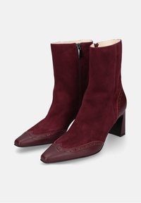 Stivaletti borgogna in suede con punta affusolata, chiusura con zip, alto tacco a blocco e cuciture decorative sulla parte superiore.