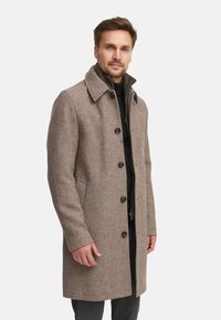 Bruine wolblend trenchcoat met een kraag, knoopsluiting aan de voorkant en zijzakken. Heeft een textuurstof en een getailleerde pasvorm.