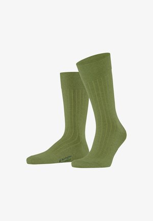 Coppia di calzini verdi a coste, lunghezza alla caviglia, con un delicato motivo a righe verticali e testo del logo vicino alle dita.