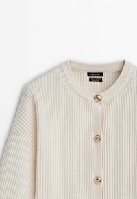 Beige ribbed cardigan made of wool and cashmere, featuring a round neckline and three gold buttons along the front closure.