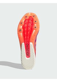 Running spike shoe sole in orange and white with six metal spikes and "ADIZERO" branding in red on the sole's midsection.