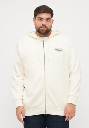 Crème kleurige ritssluiting hoodie van zachte stof, met een trekkoordkap en geborduurd logo op de borst. Ribgebreide manchetten en onderrand.