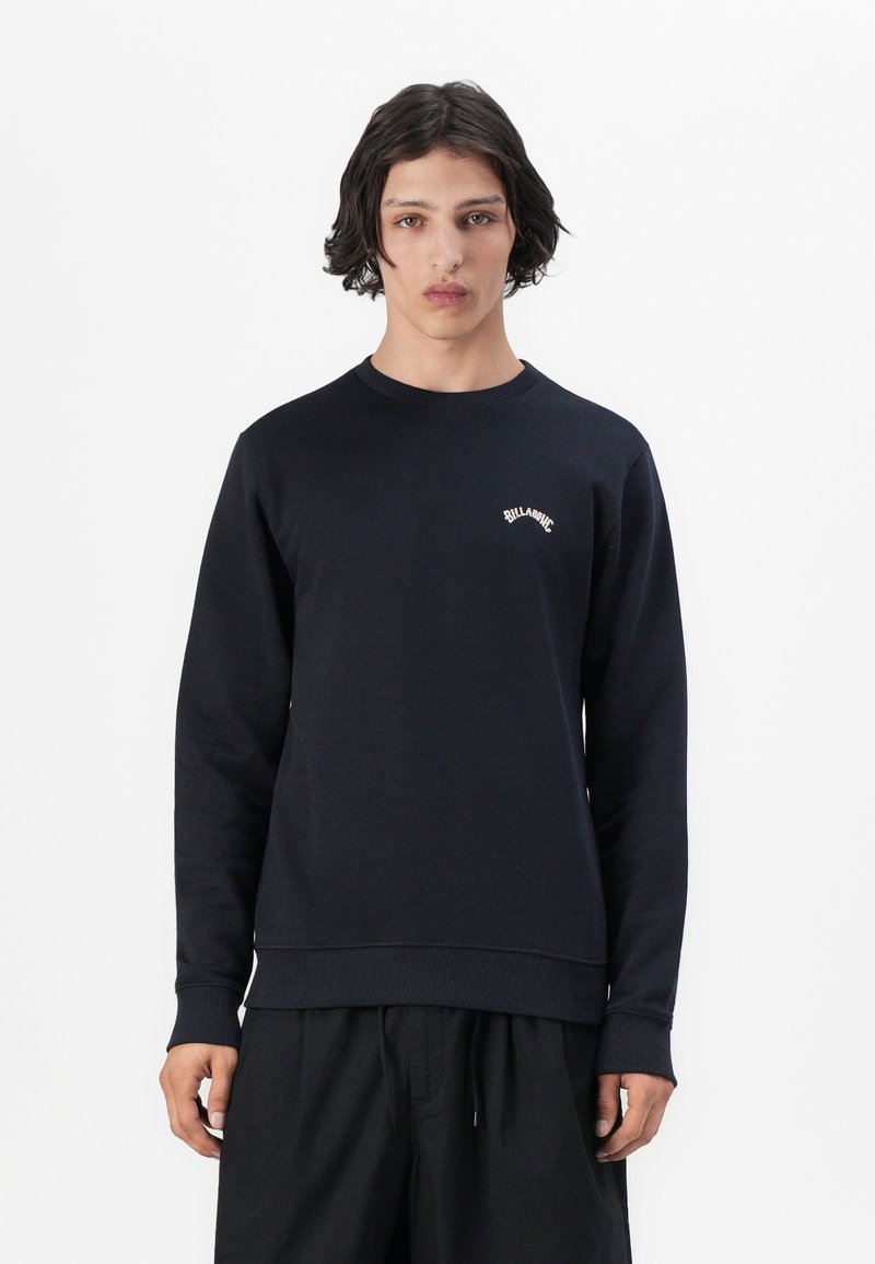 Felpa blu navy con maniche lunghe, polsini e bordo a costine. Presenta un piccolo logo bianco sul petto. Realizzata in un tessuto morbido.