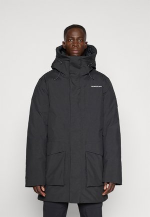 Puffer coat in black, featuring a high collar, adjustable hood, two front pockets, and a relaxed fit design. Smooth texture with minimal branding.