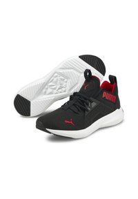 Chaussures de sport noires avec des accents rouges et gris, tige en maille texturée, col rembourré et semelle extérieure en caoutchouc blanc avec des motifs de traction.
