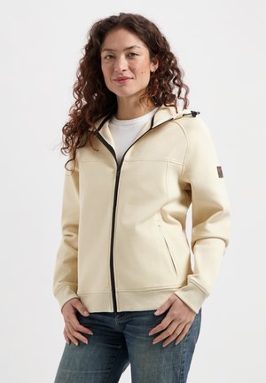 Sweat à capuche zippé beige clair avec une capuche et une fermeture éclair noire. Il dispose de poches latérales et de poignets côtelés, fabriqué dans un tissu doux et texturé.
