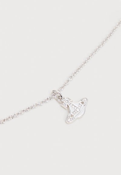 Silver chain necklace with a small orb-shaped pendant featuring a cross and circular designs.