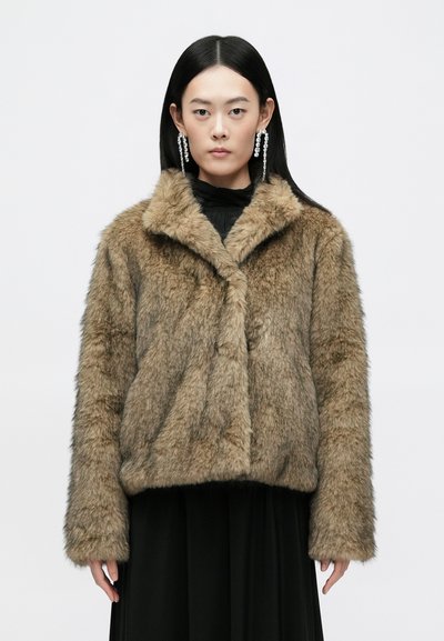 Faux fur coat in tan with a soft, textured appearance; features a notched collar, long sleeves, and a slightly cropped silhouette.