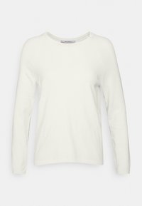 Långärmad tröja med rund halsringning i off-white. Tillverkad av mjukt tyg med en slät textur. Har raglanärmar och detaljerad sömnad i nederkant.