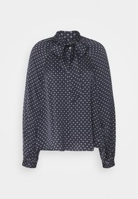 Blusa blu navy con colletto a fiocco, maniche lunghe e motivo a diamante bianco. Realizzata in tessuto leggero con polsini a bottone.