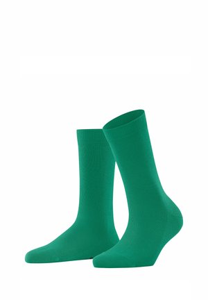 Grüne Baumwollsocken mit einem glatten Textur, geripptem Bündchen und nahtloser Zehenpartie. In einer klassischen Form für Komfort und Haltbarkeit entworfen.