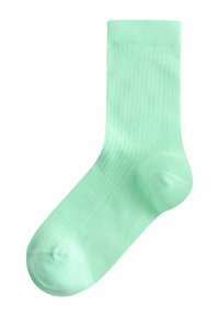 Chaussette simple vert menthe avec texture côtelée et bord élastique, présentée à plat sur un fond blanc.