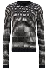 Pull en maille à motif noir et blanc avec manches longues, encolure ronde et poignets et ourlet côtelés. Présente un design ponctué sur l'ensemble.