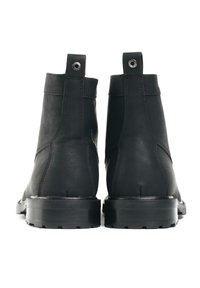 Black leather ankle boots with smooth texture, elastic side panels, pull tab, and rugged rubber sole. Design features minimal stitching details.