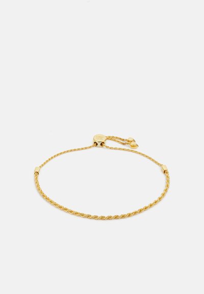 Gold braided bracelet with twisted design. Features a secure clasp and adjustable chain for fit. Smooth texture and shiny finish.