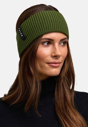 Woman wearing an olive green knit headband with a black label, paired with a black turtleneck sweater, looking to the side.