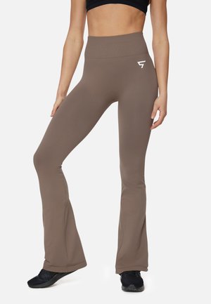 High-waisted brown flared leggings made from stretchy material, featuring a white logo on the hip and smooth, fitted texture.