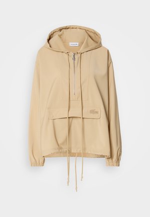 Felpa con cappuccio beige, con mezza zip, tasca a marsupio frontale, orlo con cordoncino, polsini a costine e logo ricamato sulla tasca.