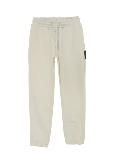 Pantaloni jogger beige con vita elastica, coulisse, tasche laterali, polsini elastici e discreto marchio "Richmond" sulla coscia destra.