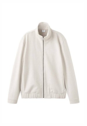 Giacca beige chiaro con zip, collo alto, polsini e orlo a coste. Tessuto morbido con una texture liscia e senza motivi o accenti visibili.
