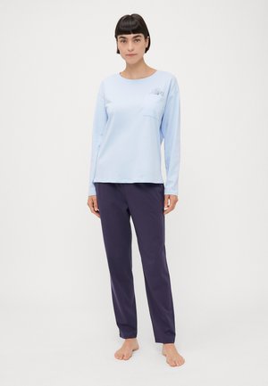 Light blue long-sleeve top with a chest pocket and floral design, paired with dark purple pants. Fabric appears soft and casual.