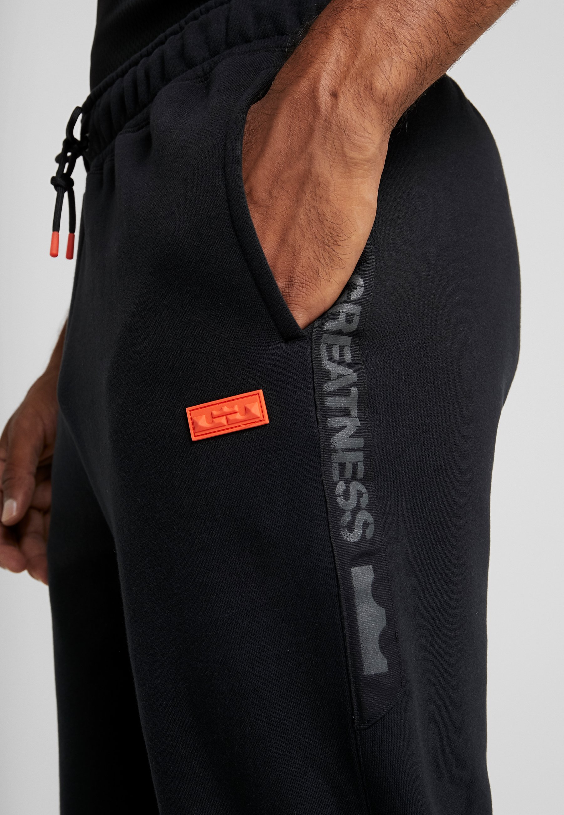 black and orange nike tracksuit